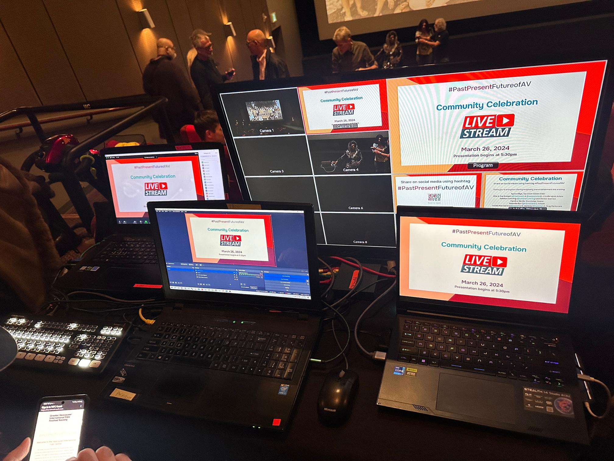 Hybrid event production in action at Vancouver Event with StreamCity.ca team handling live switching, remote guest integration, and synchronized in-room projection with broadcast feed.