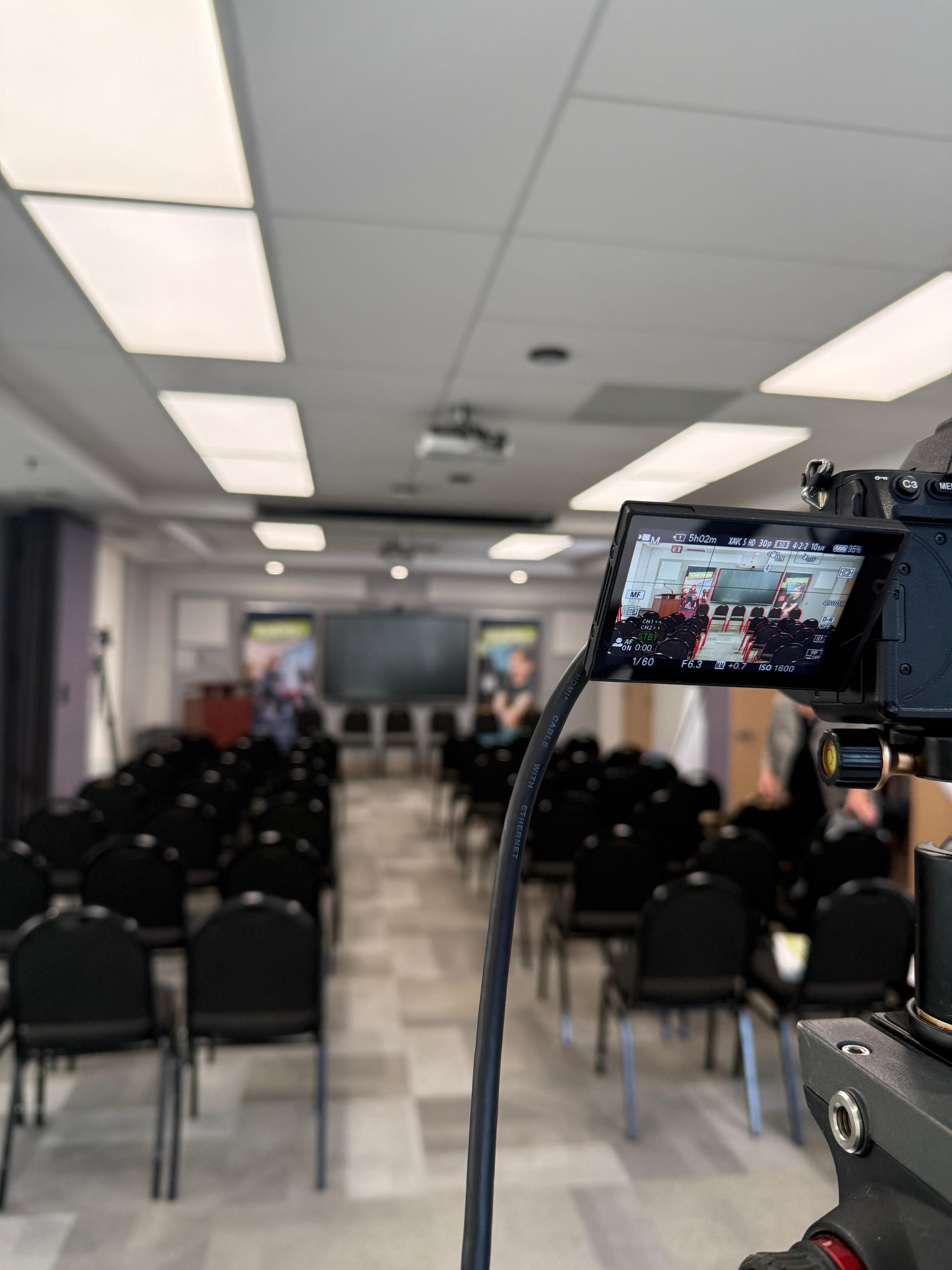 Broadcast-ready AV setup with camera positioned to record a public event in Vancouver, showing the room before attendees enter.