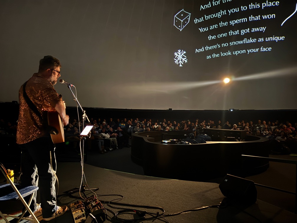 Professional audio setup for a live podcast event with microphones and control equipment