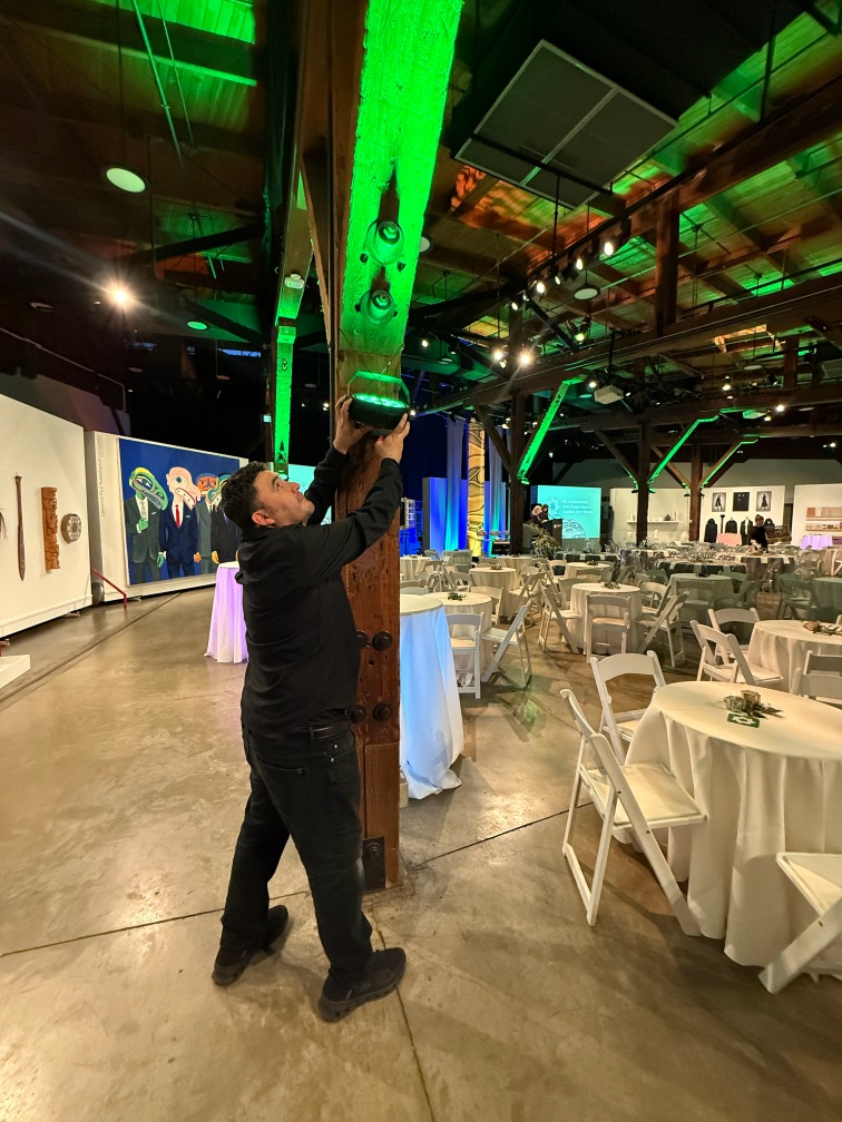 A StreamCity technician conducting a venue walkthrough to confirm AV setup, load-in logistics, and livestreaming requirements in a Vancouver event space